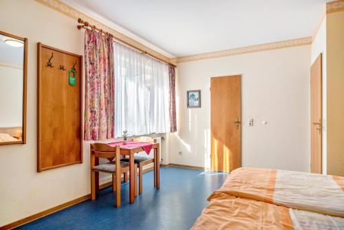 a hotel room with a bed and a table and chairs at Ferienwohnung 3 in Bernkastel-Kues
