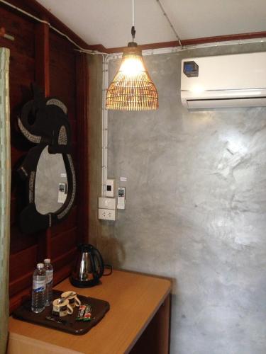 a kitchen with a table with a mirror and a light at JJ at Chiangkhan in Chiang Khan