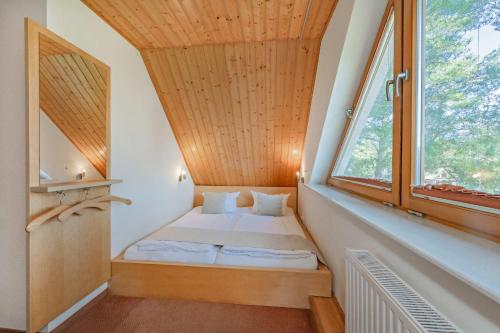 a bedroom with a bed in a room with a window at Ferienwohnung Fisch in Loddin