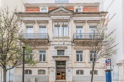 a large building with two balconies on top of it at HI Lisboa - Pousada de Juventude in Lisbon