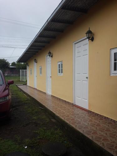 a row of doors on the side of a building at Hospedaje Rampolla's in Volcán