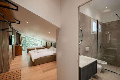a bedroom with a bed and a sink and a tub at Bianca Hotel & Villa Tirana in Tirana