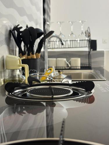 a kitchen counter with plates and utensils and a sink at Two bedrooms apartment in Moshi town in Moshi