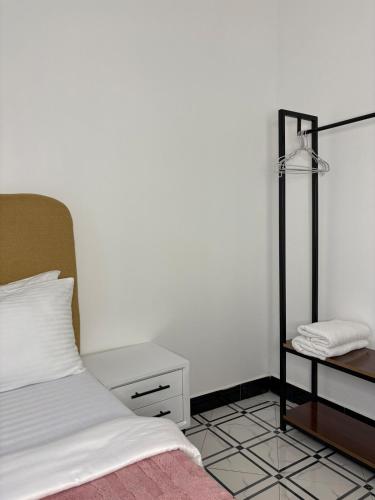 a bedroom with a bed and a table with a mirror at Two bedrooms apartment in Moshi town in Moshi