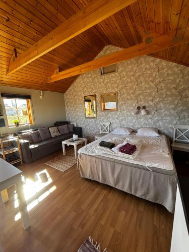 a bedroom with a bed and a stone wall at Ulvsby Ranch Western Camp in Karlstad