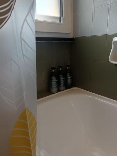 a bathroom with a toilet and a window and bottles at Ilgattonero in Orero