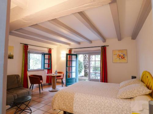 a bedroom with a bed and a table and chairs at Domaine Xixtaberri in Cambo-les-Bains