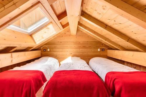 a room with two beds in a attic at Chalet Les Lys - Tout Confort in Valloire
