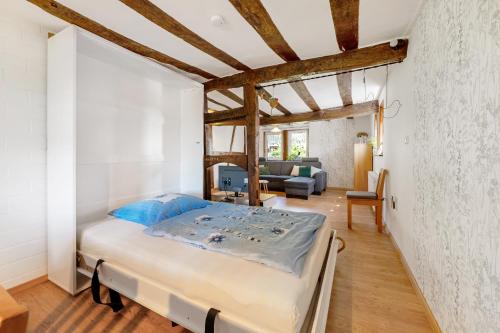 a bedroom with a bed and a living room at Ferienhäuschen Kleine Auszeit in Seesbach