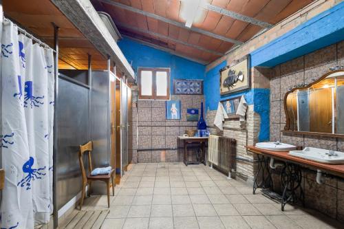 a bathroom with two sinks and blue walls at Casa refugi les Orenetes in Rocafort