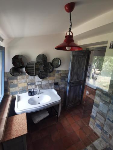 a bathroom with a sink and some pots on the wall at Domus Nirale in Bagnoregio