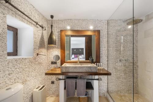 a bathroom with a sink and a mirror at Can Ribes Ibiza in Illes Balears