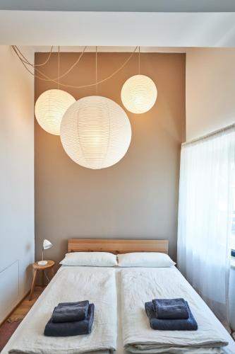 a bedroom with a bed with two towels on it at Alte Seifensiederei - Cisco in Bad Tölz