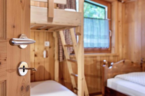 a wooden room with a bunk bed and a window at Naturidyll Mitterbach in Rio Bianco