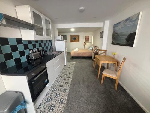 a kitchen and a living room with a bed at Duke of Albany in Weymouth