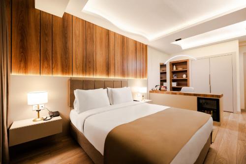 a bedroom with a large bed and a fireplace at Avwan Hotels Collection in İzmir