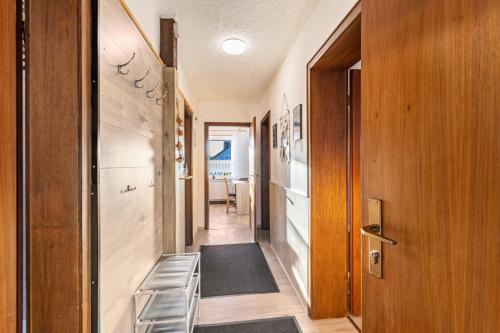 a hallway of a house with a door and a rug at Ferienwohnung Desmecke in Olsberg