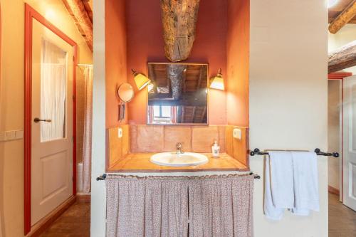 two pictures of a bathroom with a sink at La Casona y Casitas de Tabladillo in Santa María la Real de Nieva