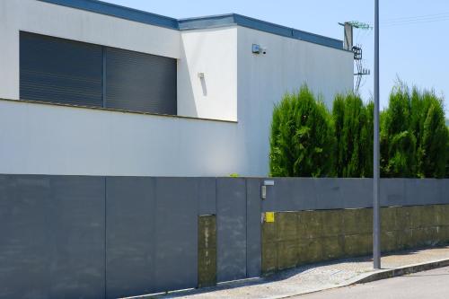 a blue and white building with a fence at Casa Horizontes de Arouca in Arouca