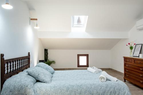 a bedroom with a large bed with towels on it at La Carbonera in Alaejos