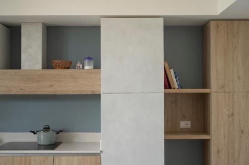 a kitchen with wooden shelves and a wall at Tenuta Vigna Corallo - Mimosa in Otranto