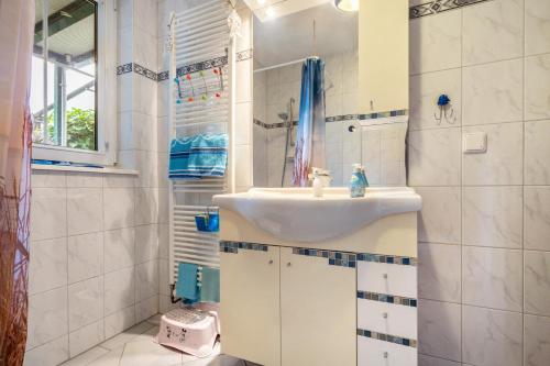a white bathroom with a sink and a mirror at Ferienwohnung Mit Maritimen Flair in Lohme
