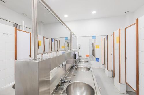 a row of sinks in a public bathroom at HI Lisboa - Pousada de Juventude in Lisbon