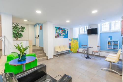 a waiting room with a table and chairs at HI Lisboa - Pousada de Juventude in Lisbon