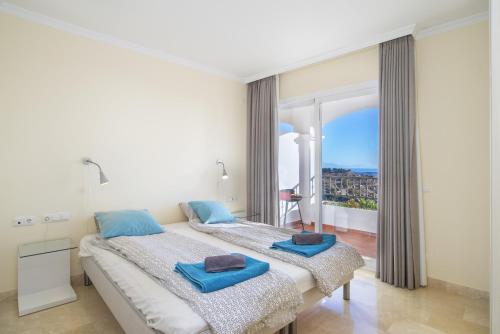 a bedroom with a bed and a large window at Astonishing view modern apartment in Sitio de Calahonda