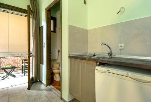 a kitchen with a sink and a toilet in a room at Old Boat double studio 2 in Nikiana