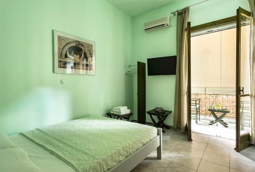 a bedroom with a bed and a view of a balcony at Old Boat double studio 2 in Nikiana
