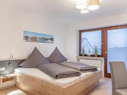 a bedroom with a bed with pillows on it at Comfort Apartment Buchhorn in Friedrichshafen