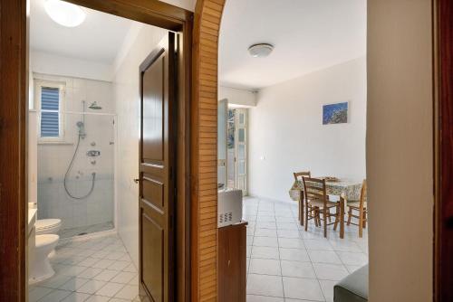 a bathroom with a shower and a toilet and a table at Villa Azzurra in Massa Lubrense