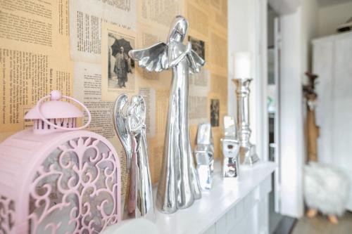 a shelf with silver faucets on a wall at Ferienwohnung Doris in Viöl