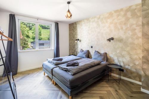a bedroom with a bed and a window at Haus Waldberg in Unterschönau