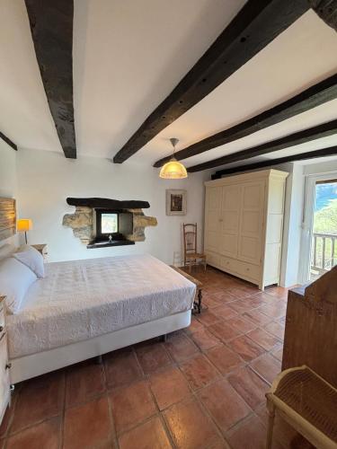 a bedroom with a bed and a fireplace at Iregi Natura Casa Rural in Oskotz