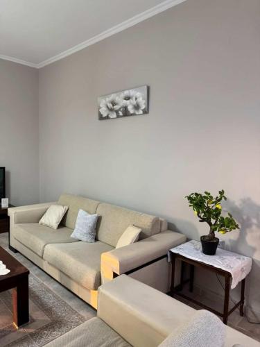 a living room with a couch and a table at Val's place in Mytilene