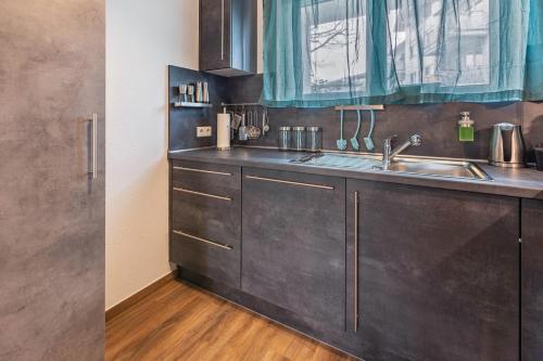a kitchen with stainless steel cabinets and a sink at Hotz in Radolfzell am Bodensee