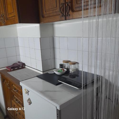 a kitchen with a counter with a bowl of food on it at Apartman Suva reka in Leskovac