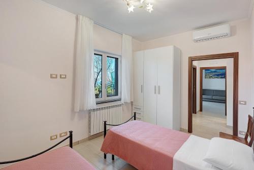 a bedroom with a bed and a window at Casa Vacanza Anni' in Vico Equense