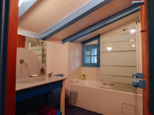a bathroom with a tub and a sink and a shower at Domaine Xixtaberri in Cambo-les-Bains