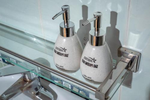 two bottles of soap sitting on a glass shelf at South Star Hotel in Ninh Binh