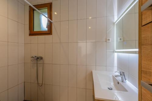 a white bathroom with a sink and a shower at Les Sources Gîte calabert in Chambonas