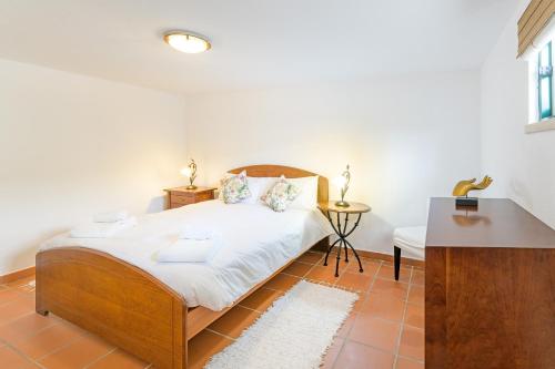 a bedroom with a bed and a desk in a room at Casa de praia na costa da Galé in Melides