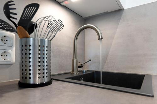 a kitchen counter with a sink and a knife holder at Ferienappartement Holm Ostsee in Brasilien