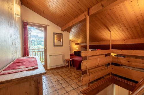 a room with a wooden staircase in a house at Chalet de la Marmotte in Crest-Voland