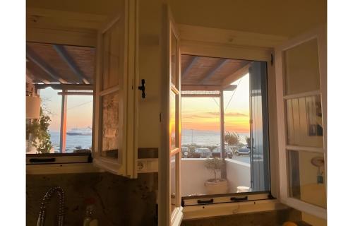 a window in a bathroom with a view of the ocean at Waterfront Masterpiece in Tinos