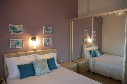 a bedroom with two beds and a large mirror at Tigani House in Tyros