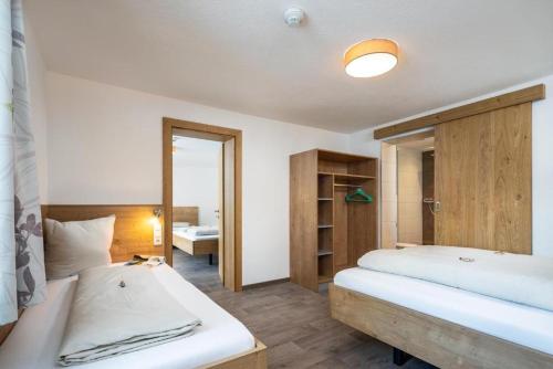 a bedroom with two beds and a mirror at Haus Sabrina Kreuzjoch in See
