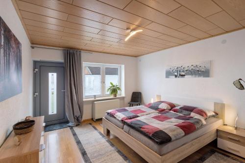a bedroom with a bed and a wooden ceiling at Naturoase Fichtelberg in Fichtelberg